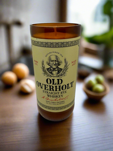 Old Overholt whiskey bottle on a wooden surface with blurred background